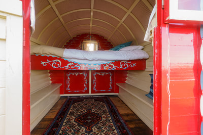 Cozy interior of our Gypsy Caravan featuring inviting furnishings and charming details